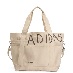 Beige tote bag with 'Adidas' branding on a white background