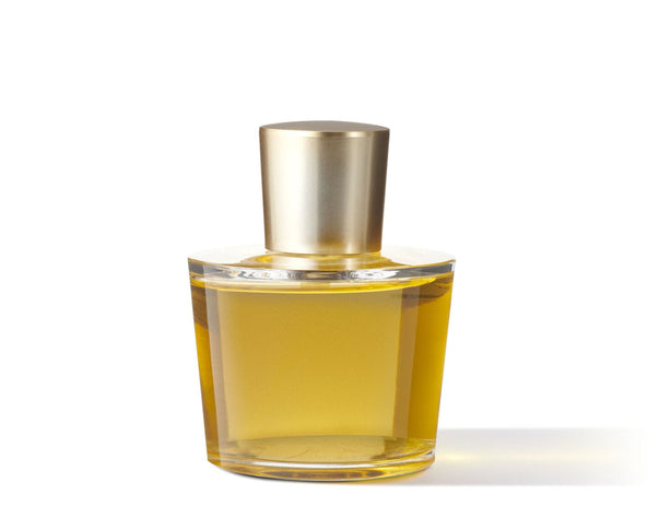 Clear glass perfume bottle with gold cap on a white background