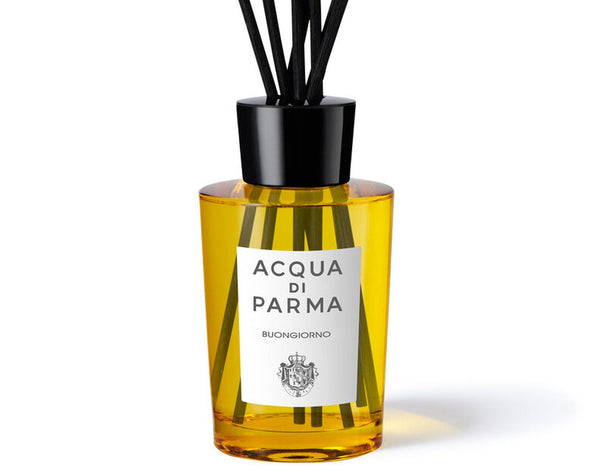 Acqua di Parma diffuser bottle with black sticks on a white background