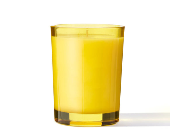 Yellow glass filled with a yellow liquid on a white background