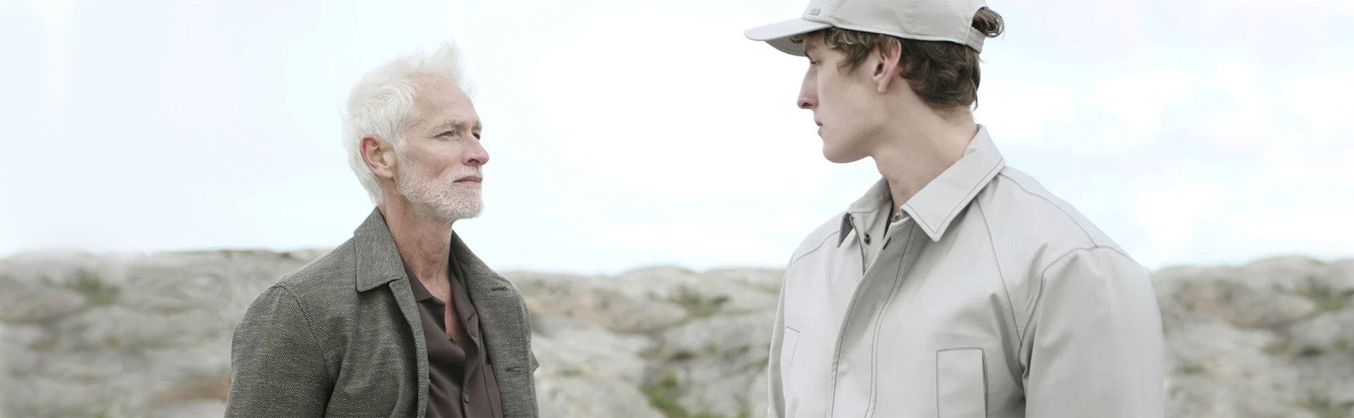 Herno two models wearing designer outerwear outdoors, showcasing style and fit.