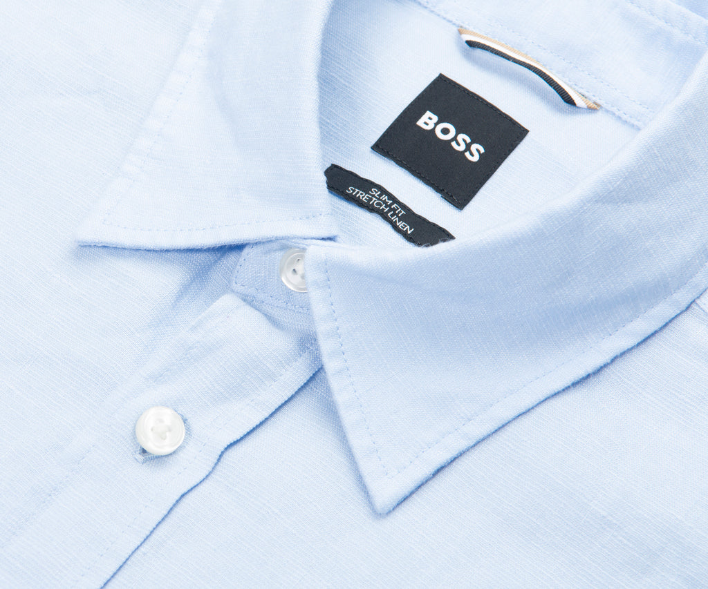 Close-up of a light blue shirt collar with a BOSS label.