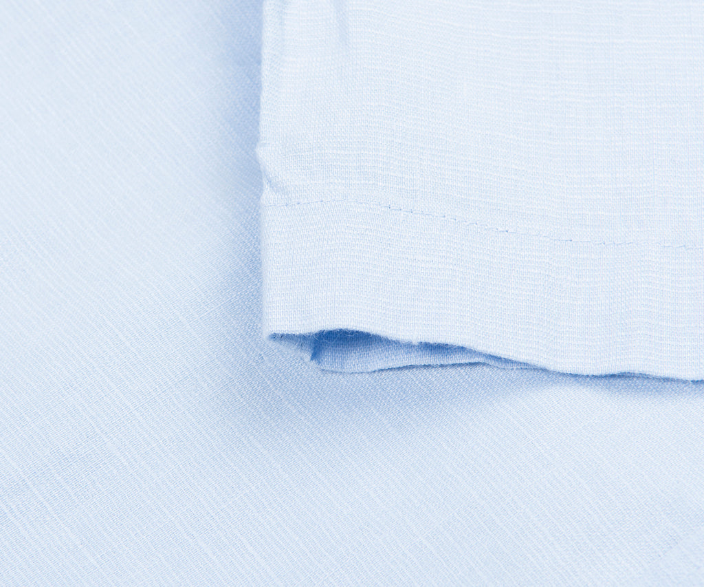 Close-up of light blue fabric with a subtle pattern