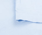 Close-up of light blue fabric with a subtle pattern