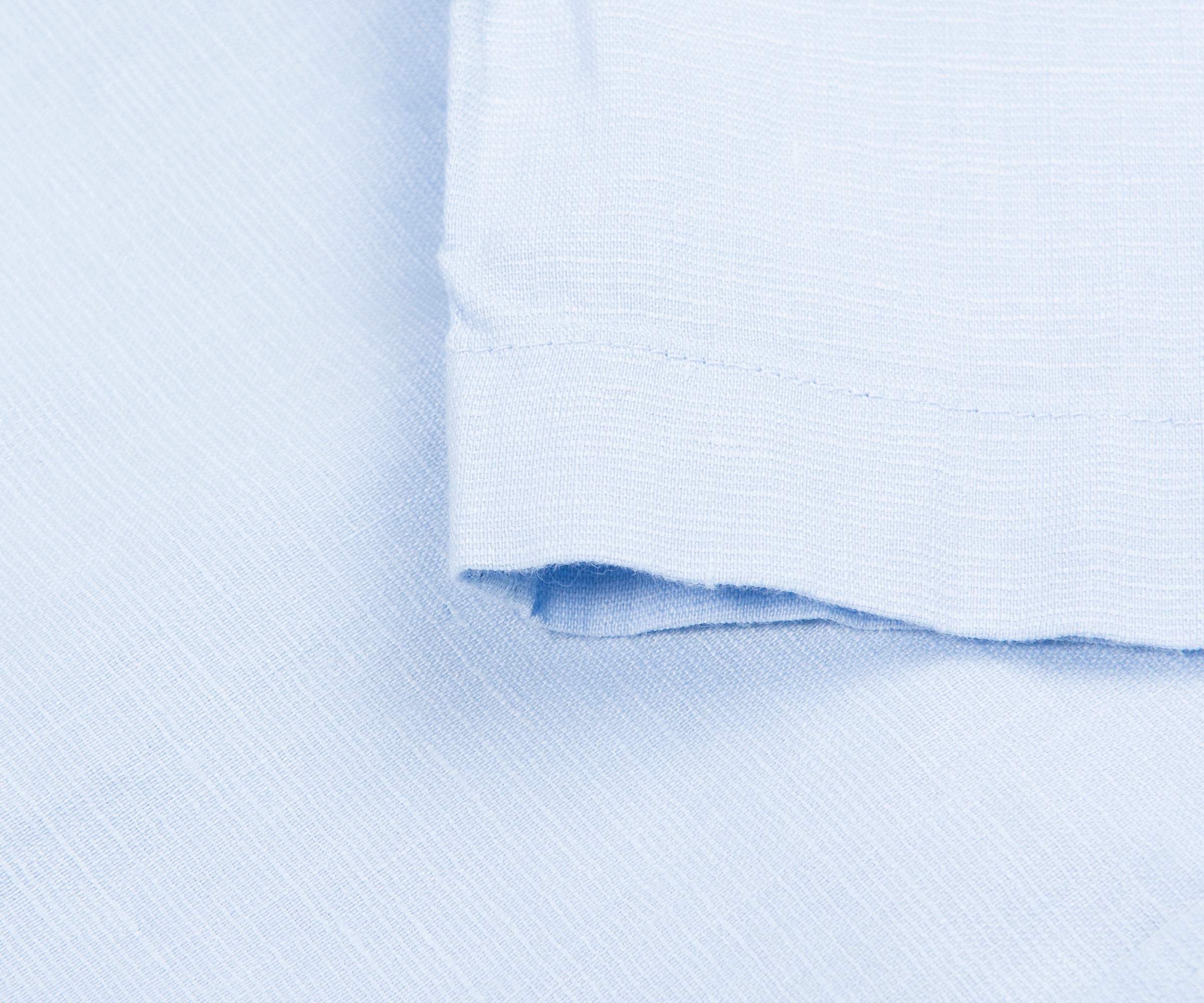 Close-up of light blue fabric with a subtle pattern
