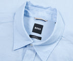 Light blue dress shirt with a Boss label on a light blue background