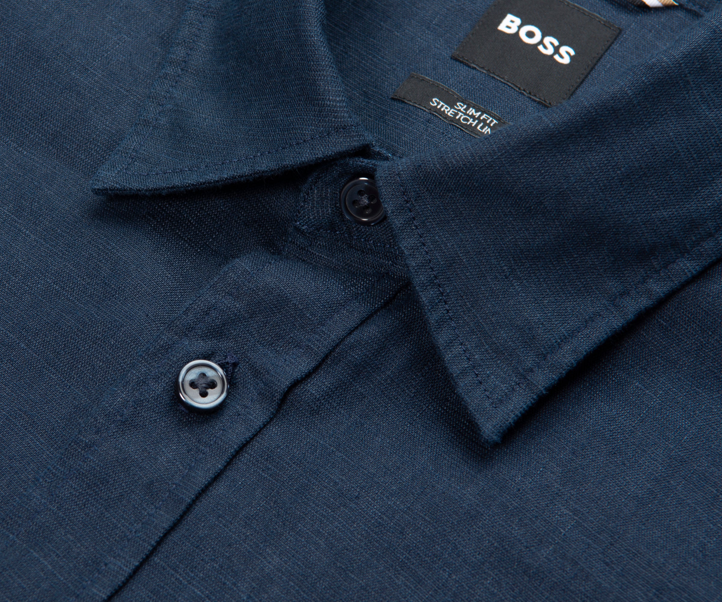 Close-up of a navy blue shirt with a BOSS label on the collar.