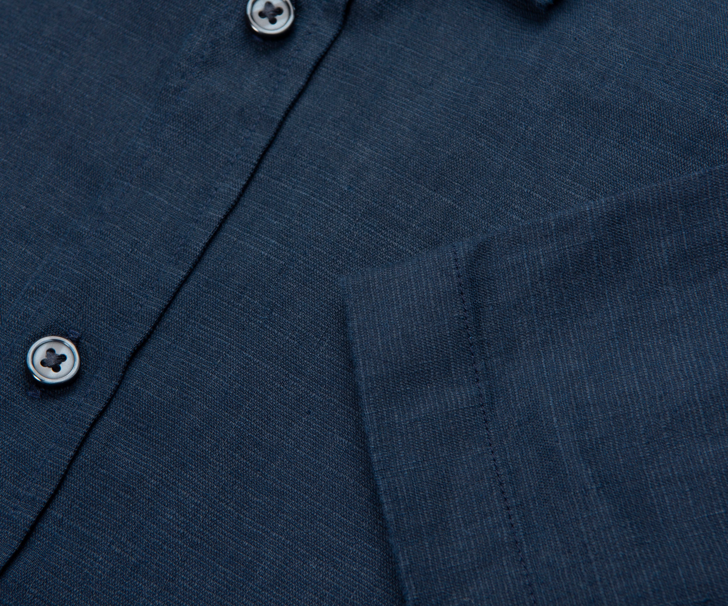 Close-up of a navy blue shirt with button details