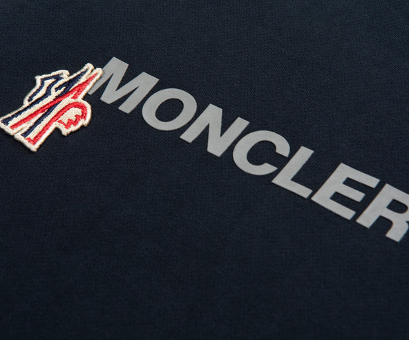 Moncler logo on a dark background