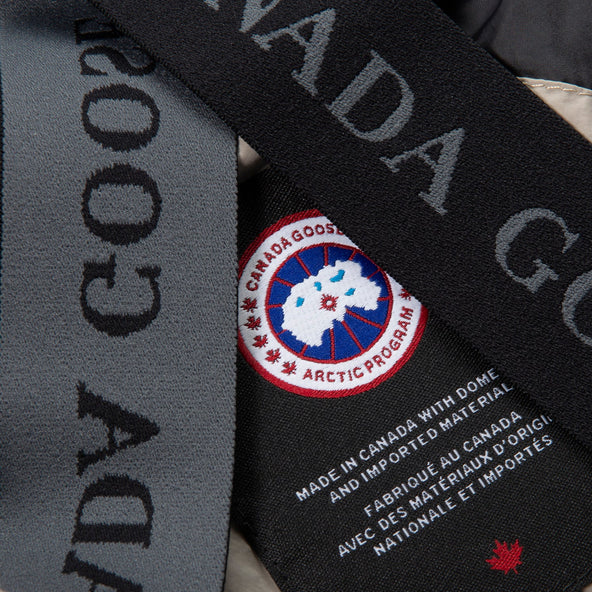Canada Goose jacket with brand logo and text on a black strap.