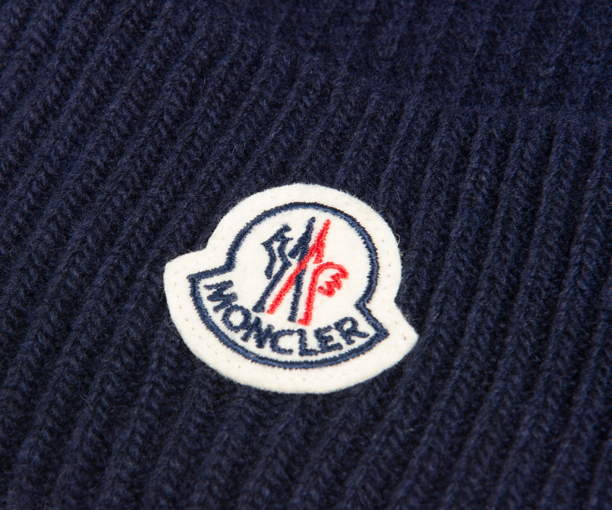 close-up of Moncler logo on a navy beanie