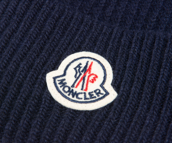 close-up of Moncler logo on a navy beanie