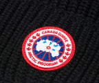 close-up of Canada Goose logo on a black beanie | Pockets