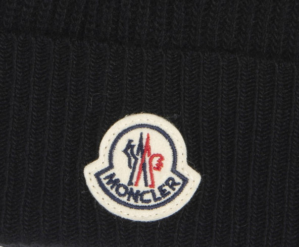 Close-up of Moncler logo on a black beanie
