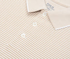 Close-up of a beige and white striped Polo Ralph Lauren shirt.