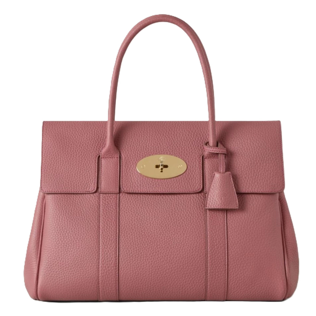 Pink handbag with a gold clasp on a white background