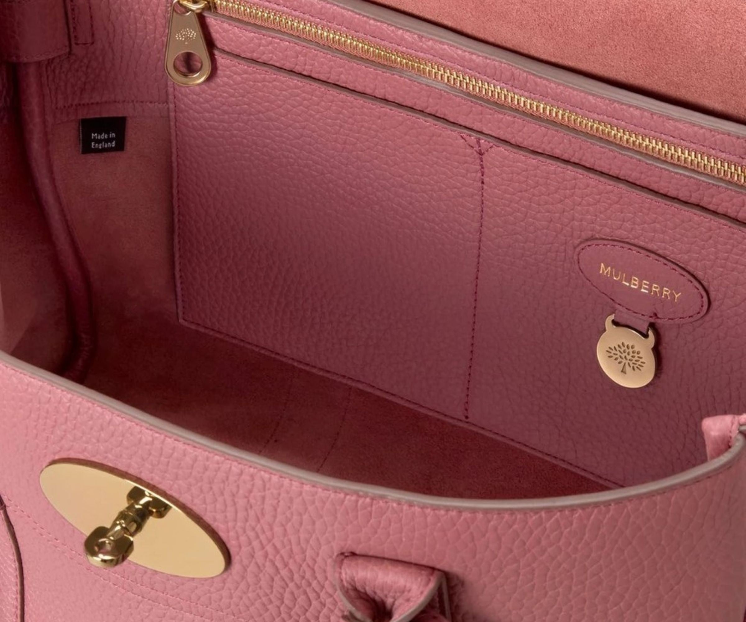 Close-up of a pink Mulberry handbag with gold hardware.