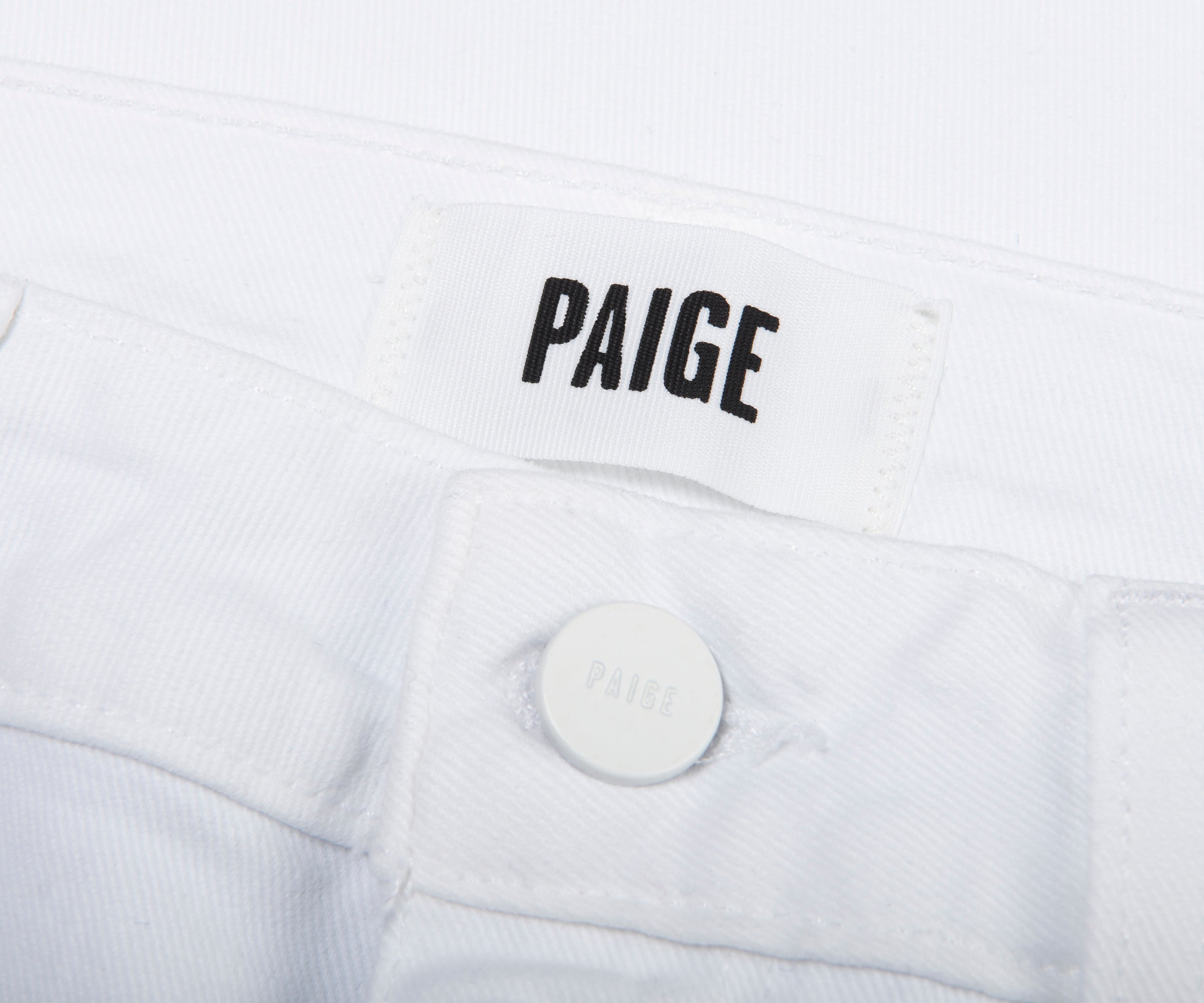 White jacket with 'PAIGE' branding on a white background