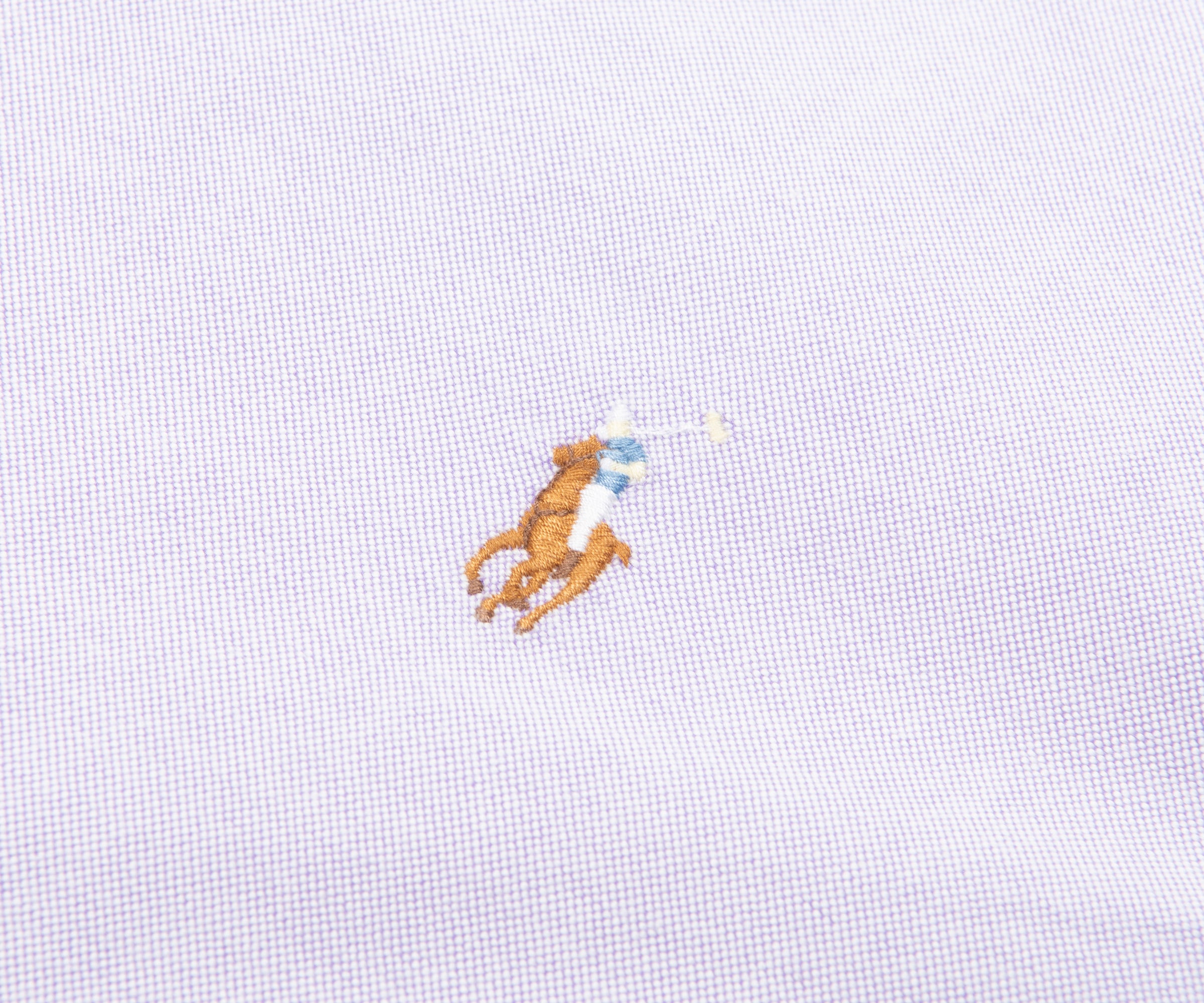 Embroidered logo on a light blue shirt