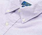 Close-up of a light purple shirt with white buttons and Polo Ralph Lauren label.