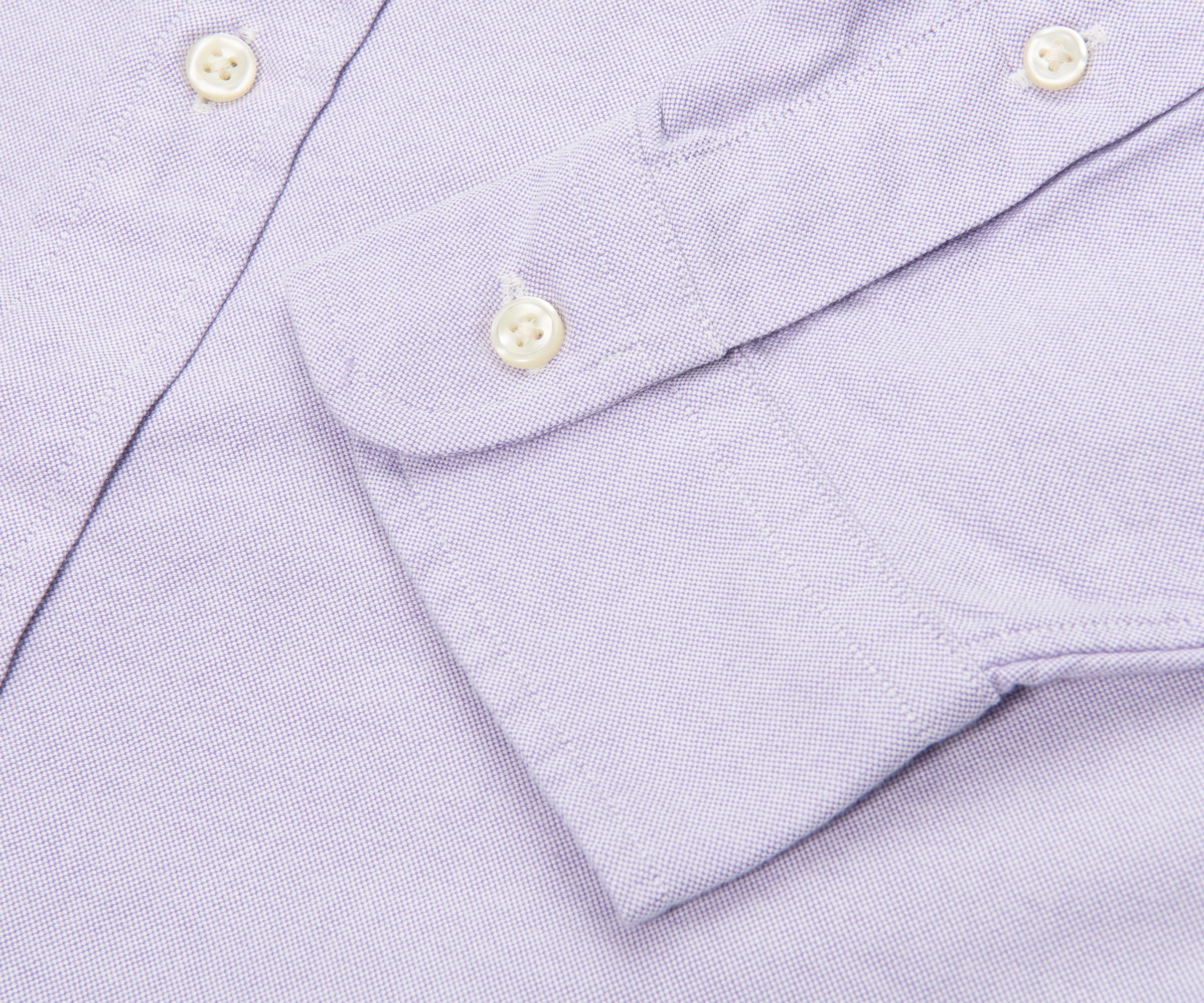 Close-up of a light purple shirt with button details