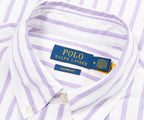 Close-up of a Polo Ralph Lauren shirt with a label on a white and purple striped background