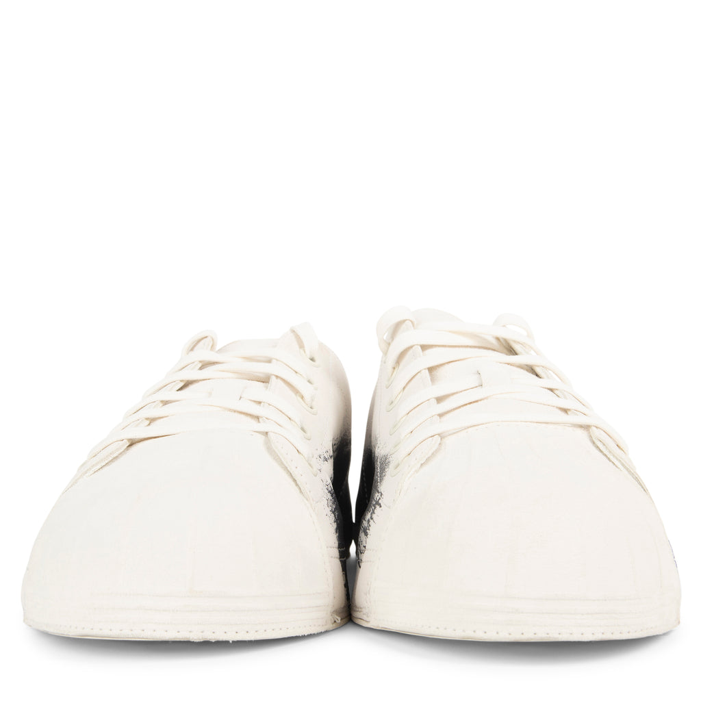 Pair of white sneakers on a white background