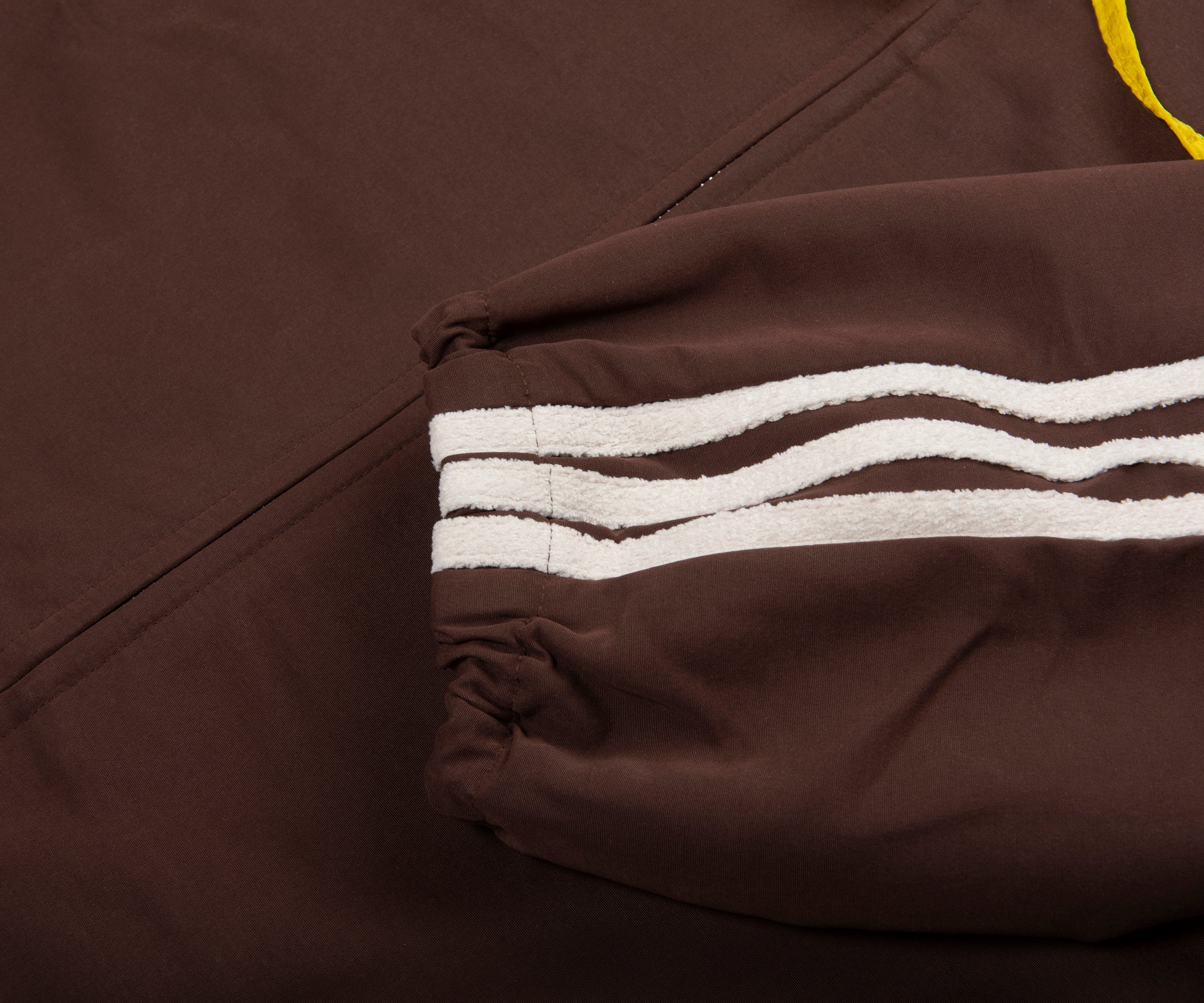 Brown jacket with white stripes on a dark background