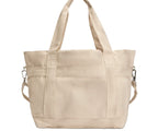 Beige tote bag with multiple pockets on a white background