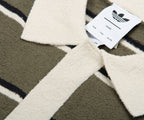 Textile product with Adidas label on a geometric patterned background