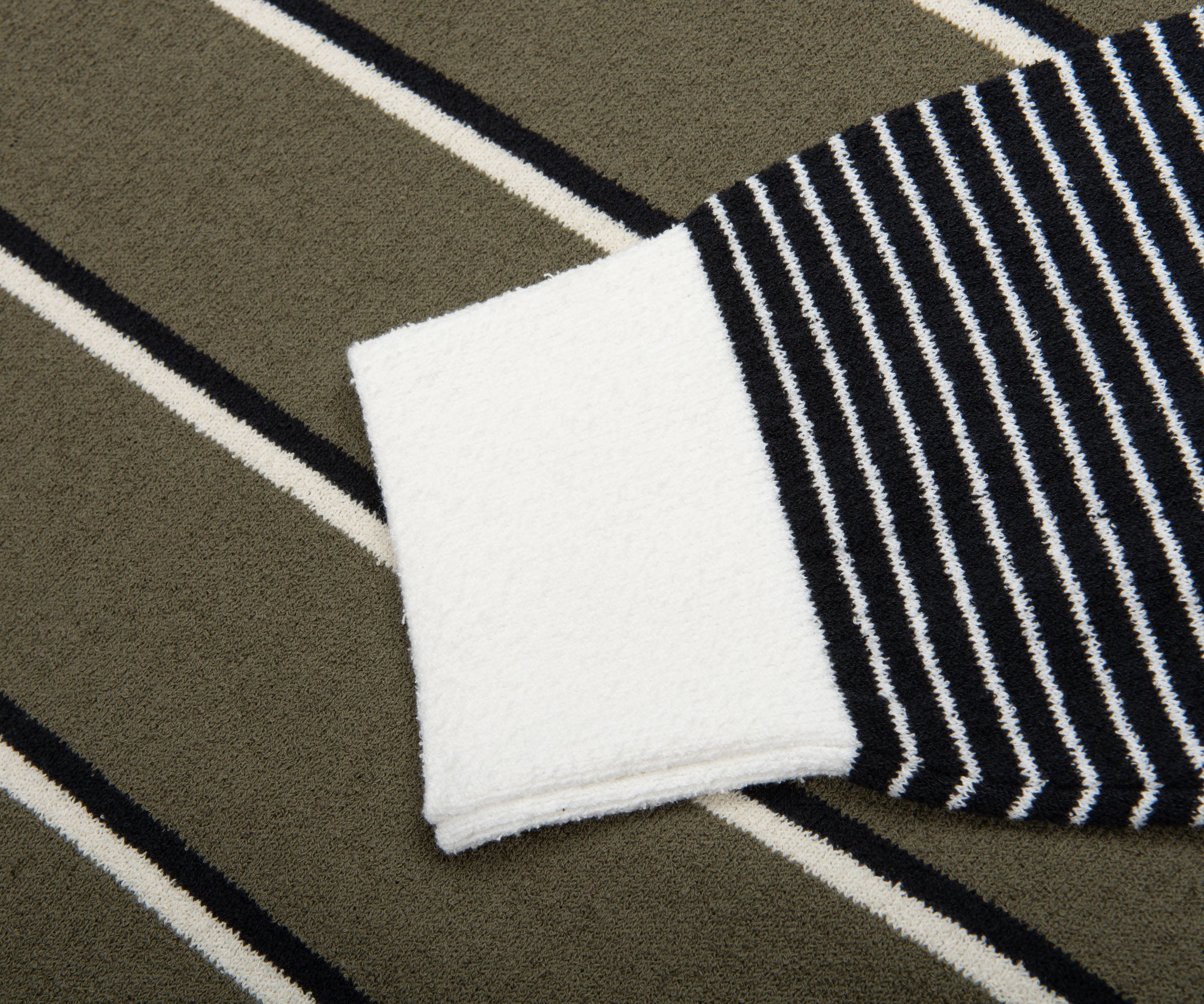 Close-up of a black and white striped sock on a striped fabric background