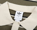 Close-up of a sweater with an Adidas label on a patterned background