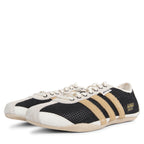 Black and white sneakers with beige accents on a white background