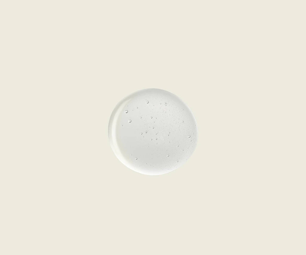 Round white plate with speckled pattern on a beige background