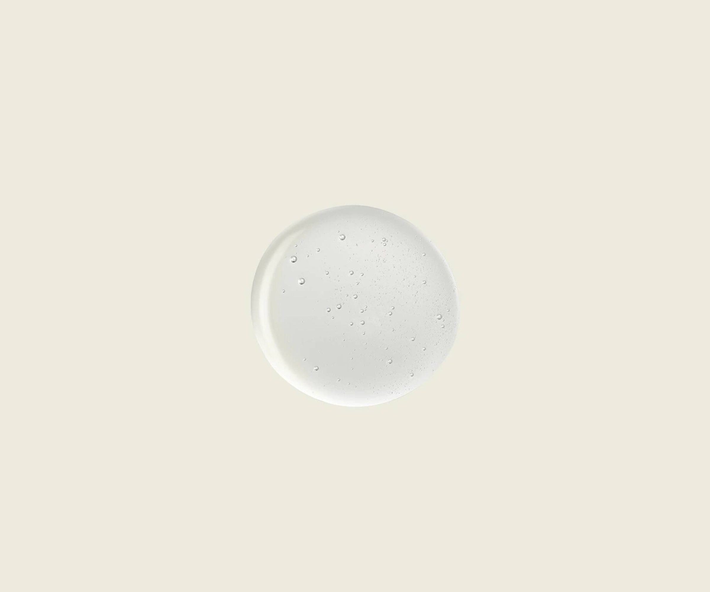 Round white plate with speckled pattern on a beige background