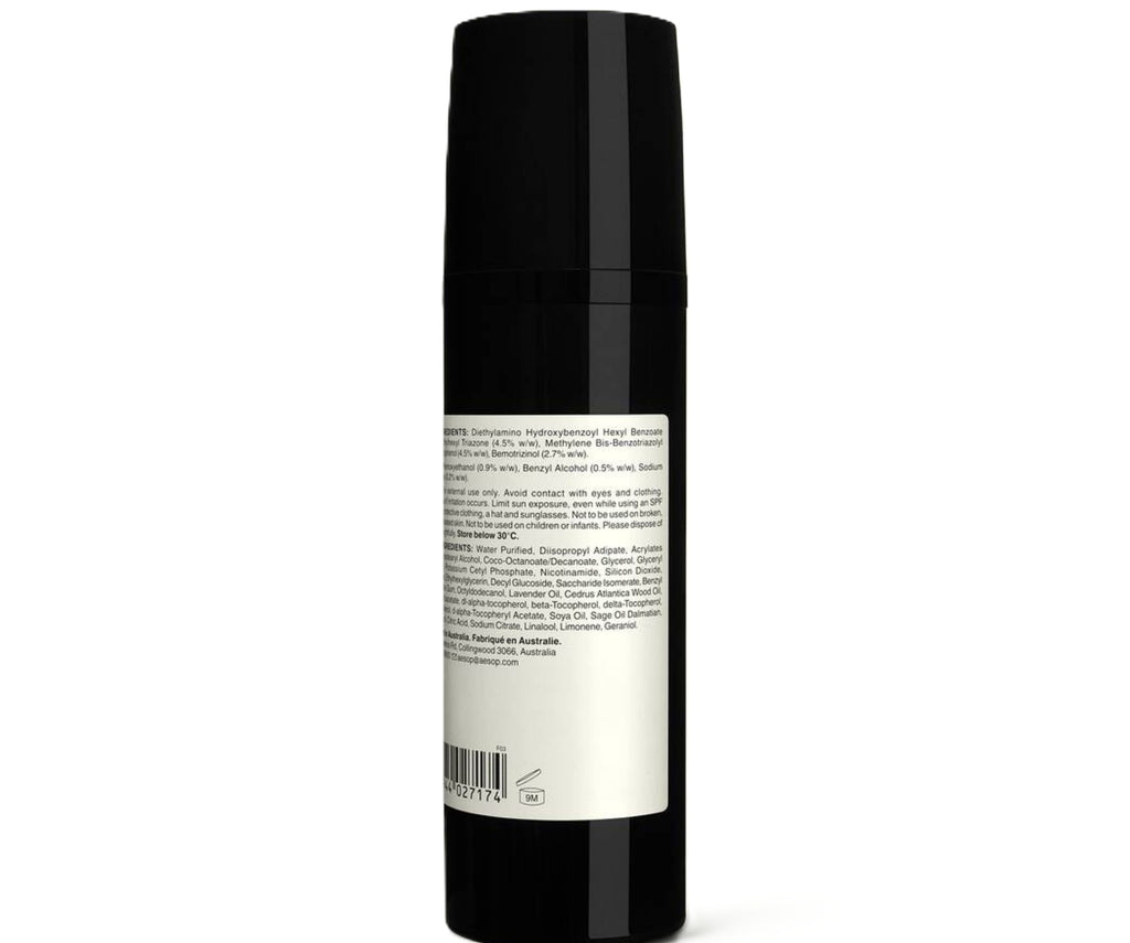 Black cylindrical bottle with a label on a white background