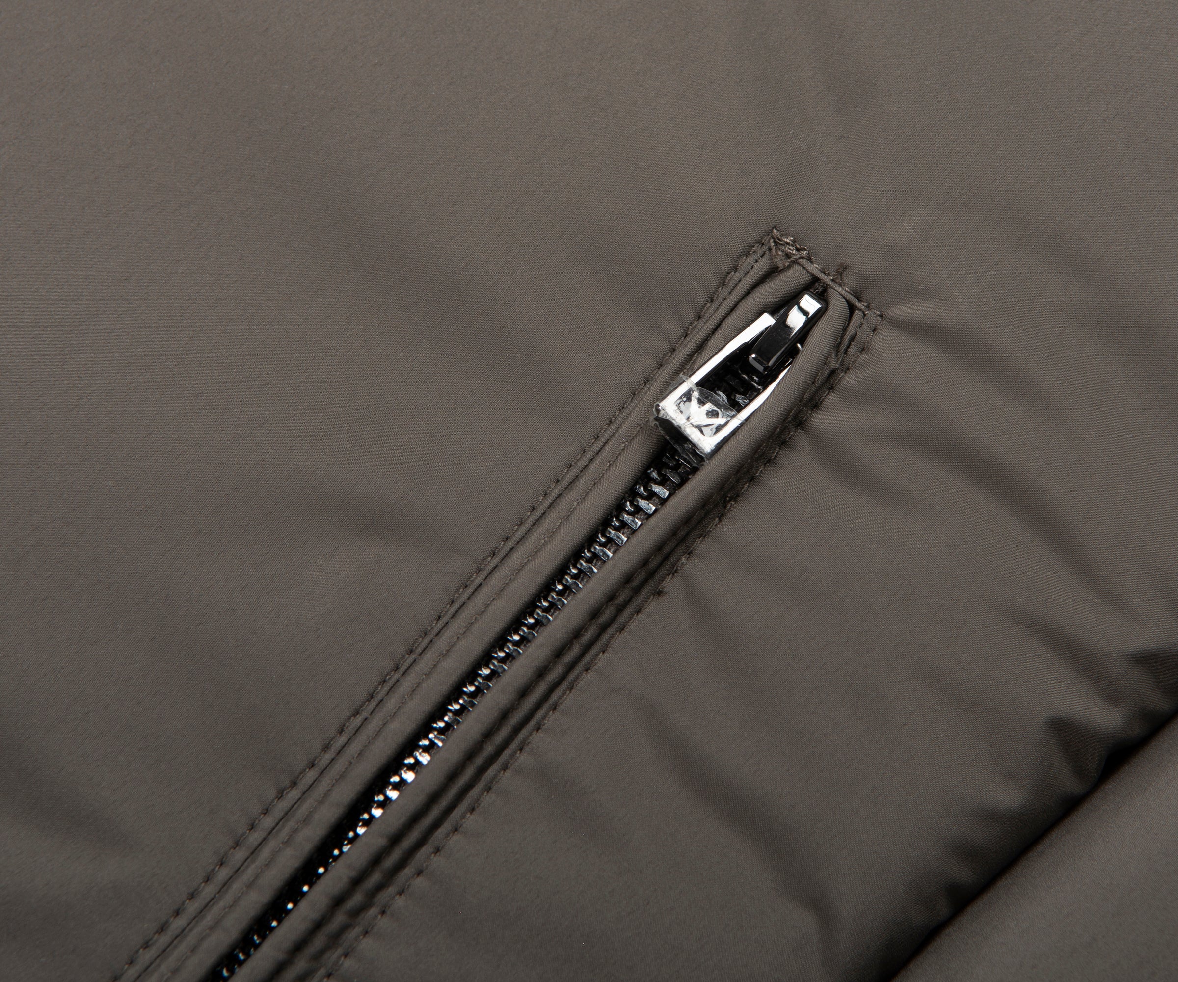Close-up of a zipper on a gray jacket