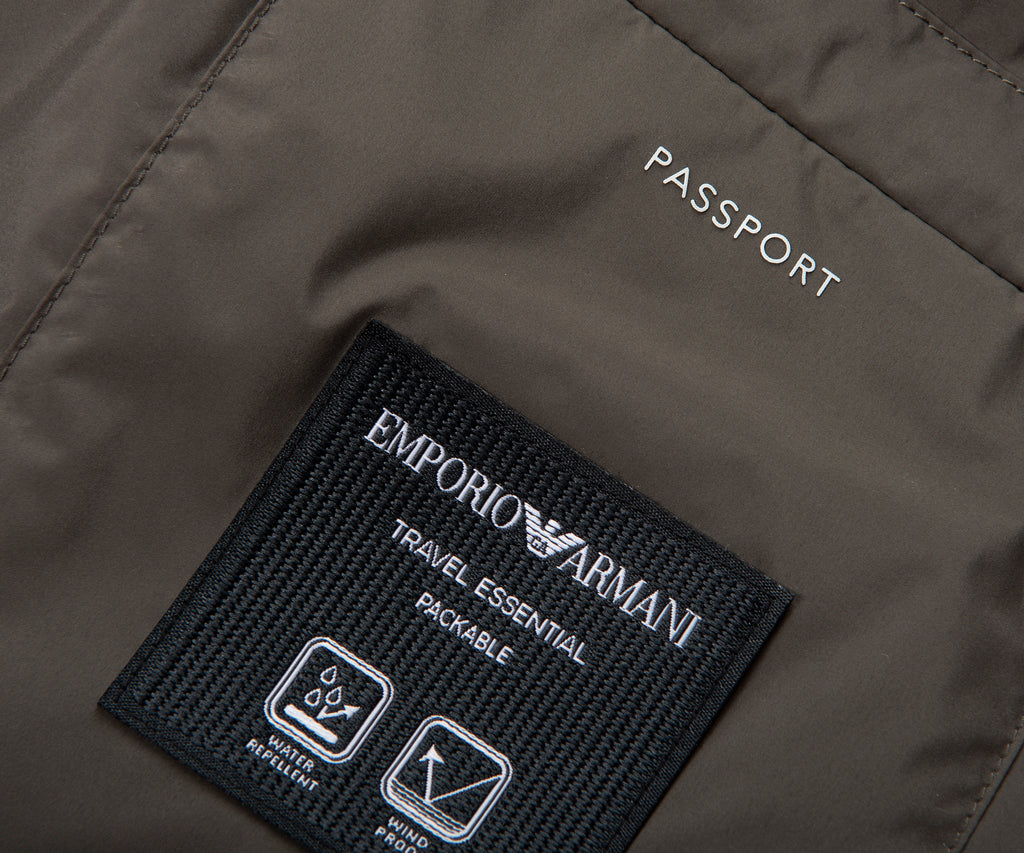 Emporio Armani label on a dark gray jacket with 'PASSPORT' text.
