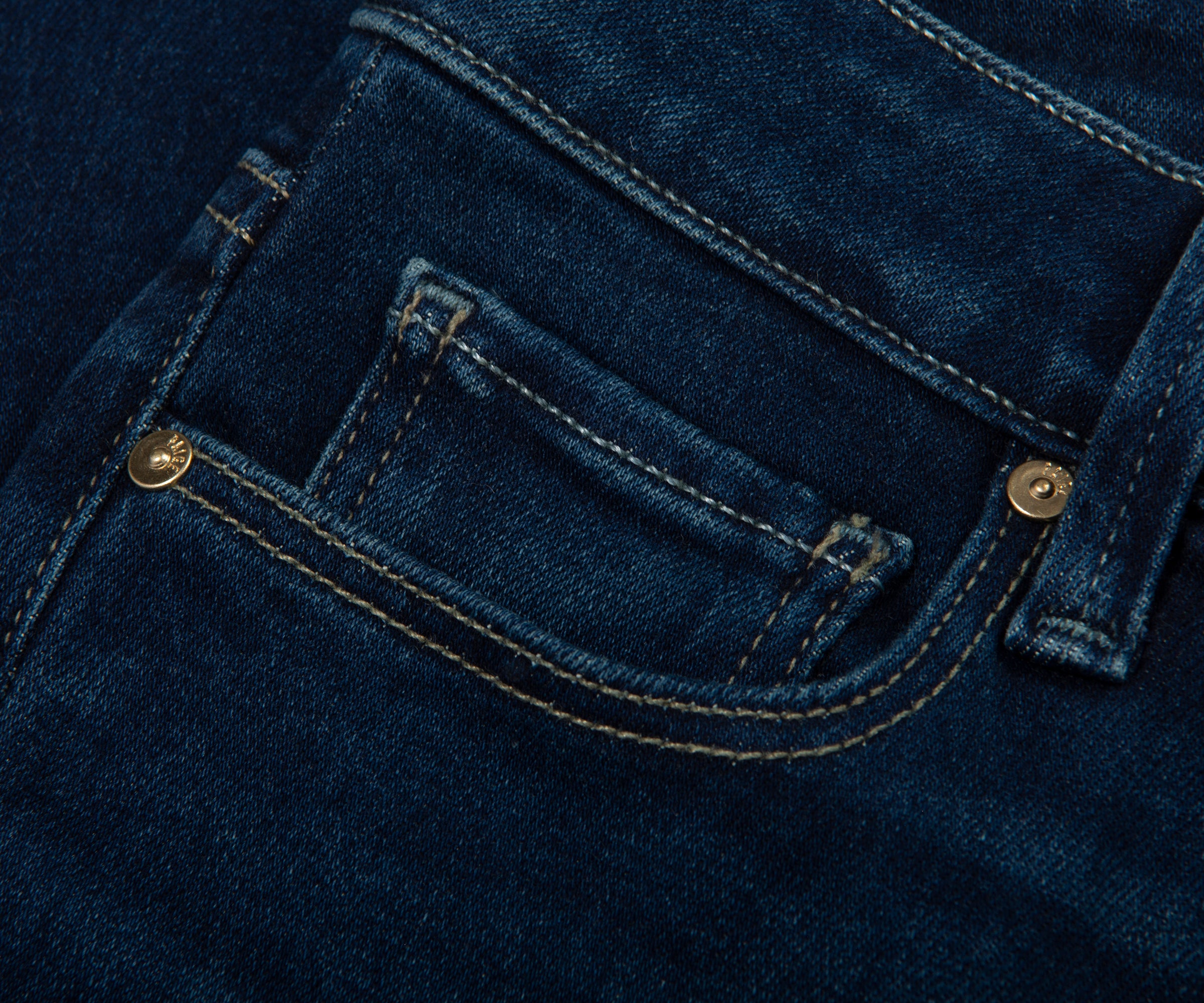 Close-up of blue denim fabric with stitching details