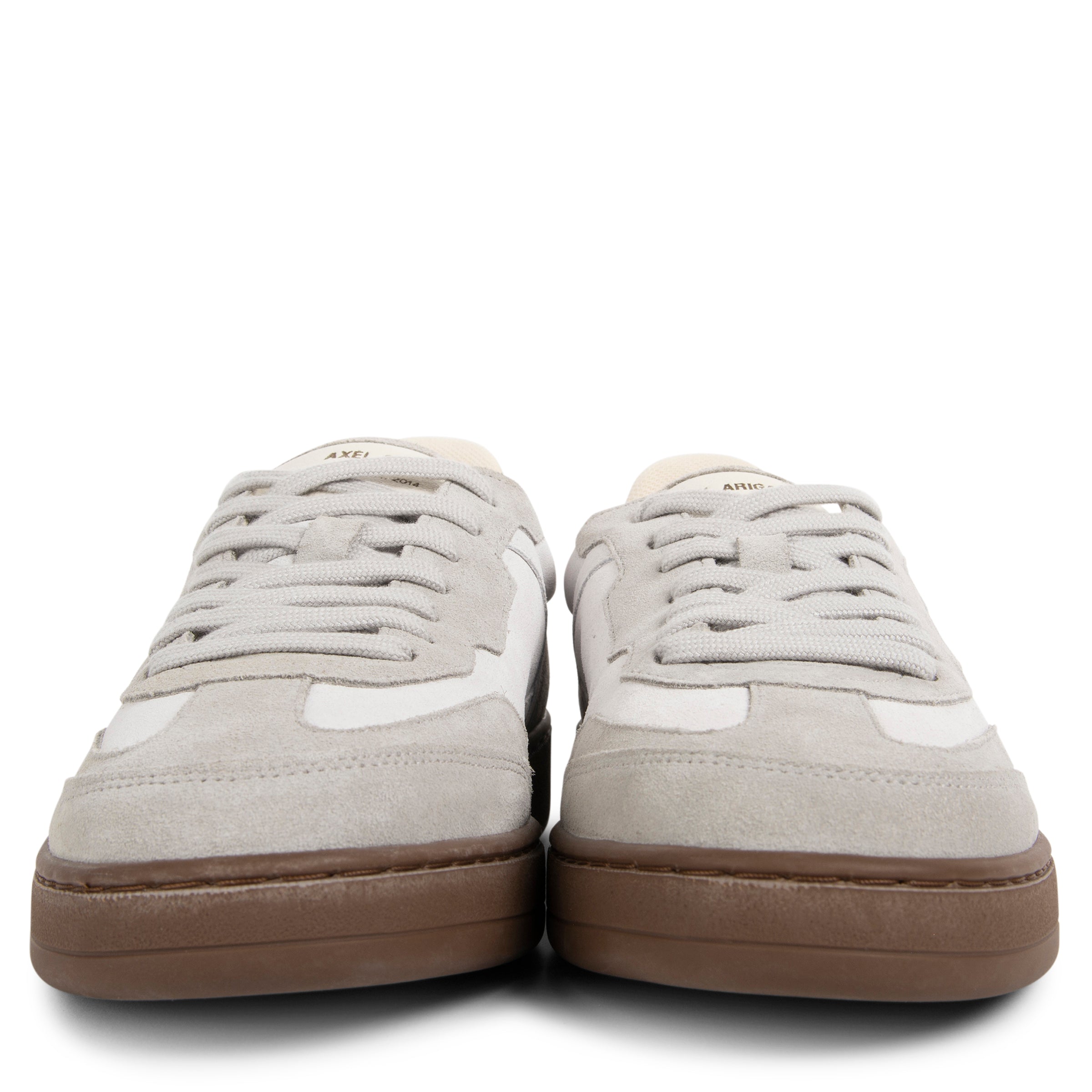 Pair of light gray sneakers with brown soles on a white background