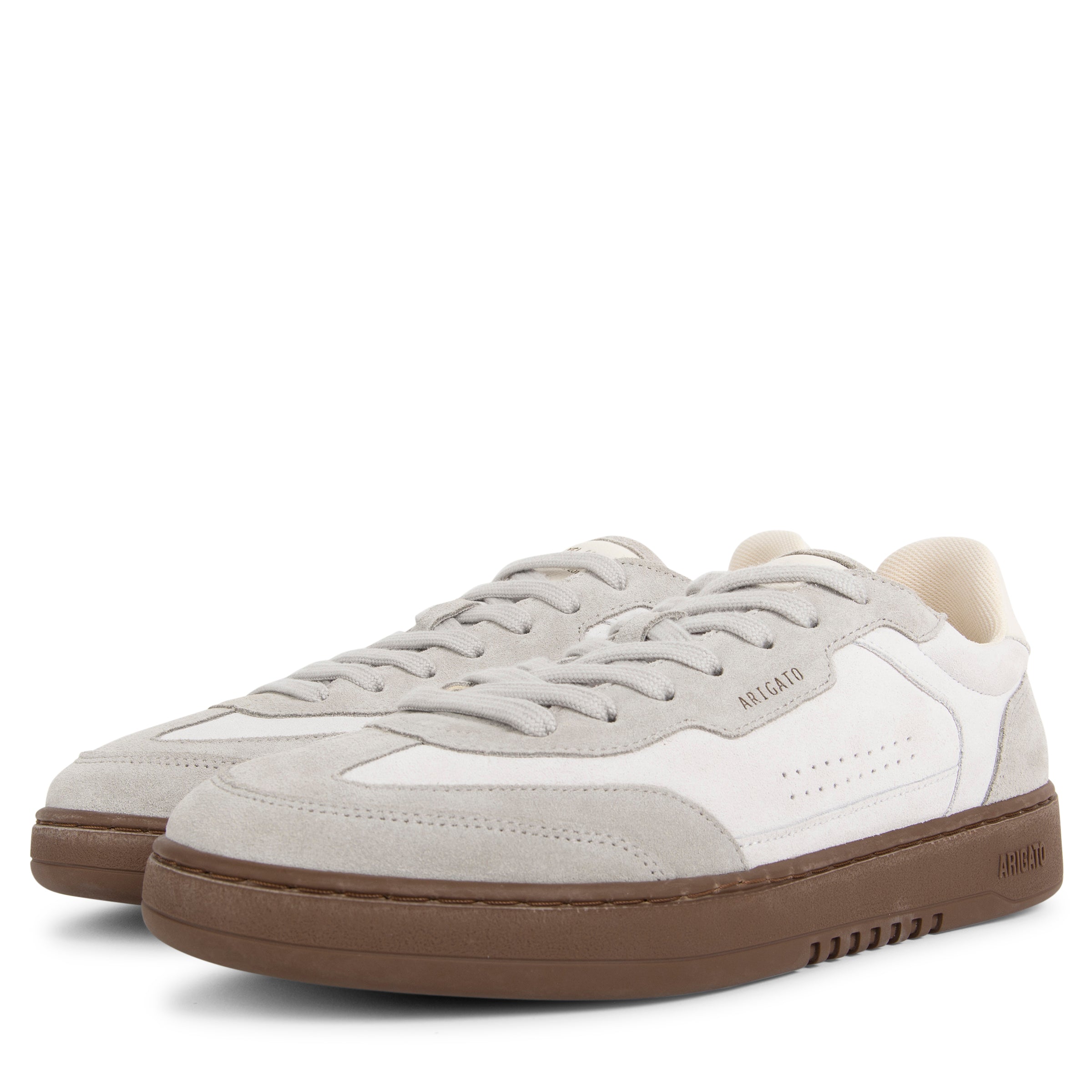 Pair of light gray and white sneakers with brown soles on a white background