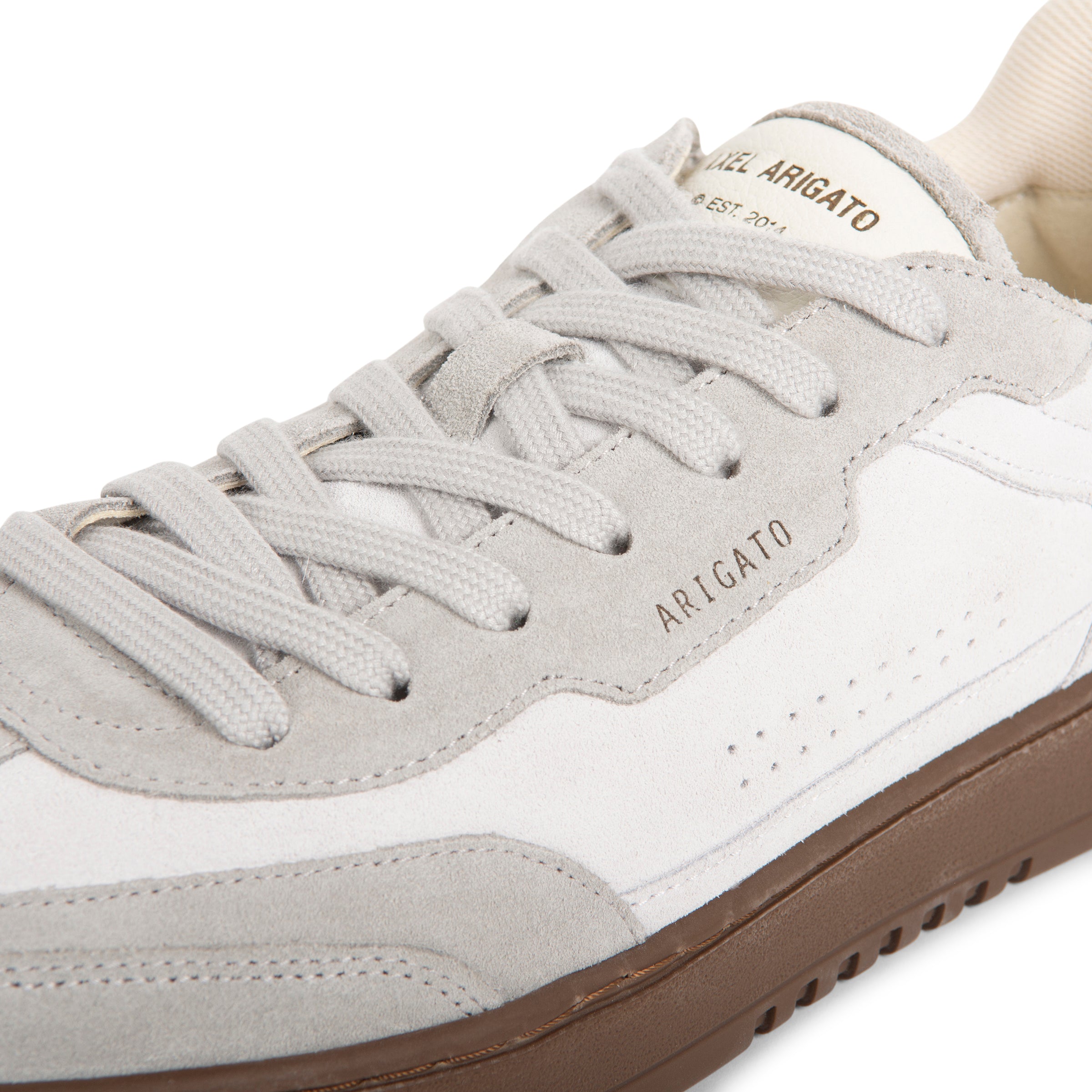 Gray and white sneaker with 'ARIGATO' branding on a white background