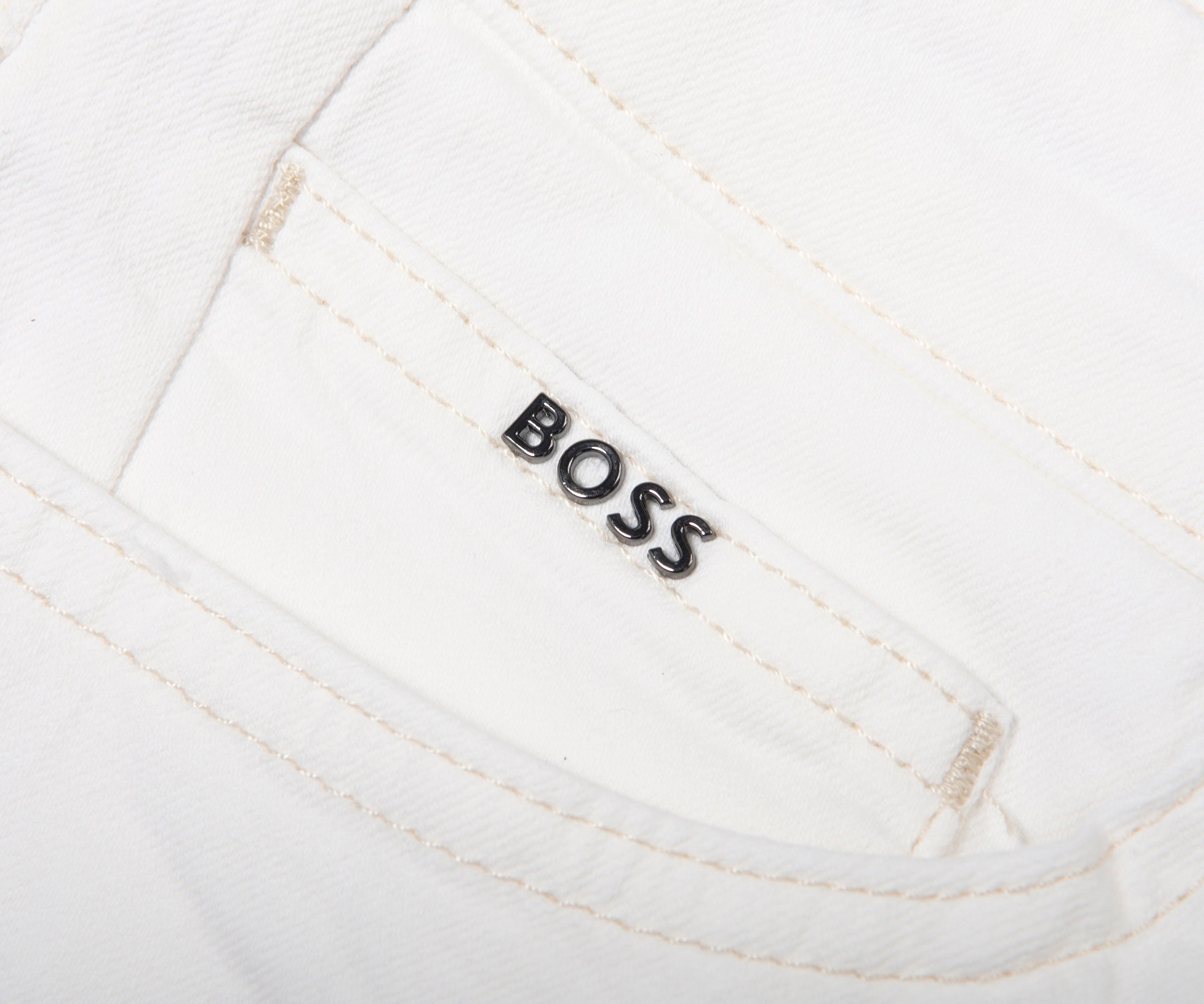 Close-up of a white garment with 'BOSS' logo on a white background
