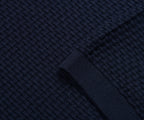 Close-up of dark blue textured fabric with a woven pattern