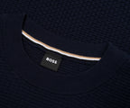 Close-up of a navy sweater with a visible Boss label