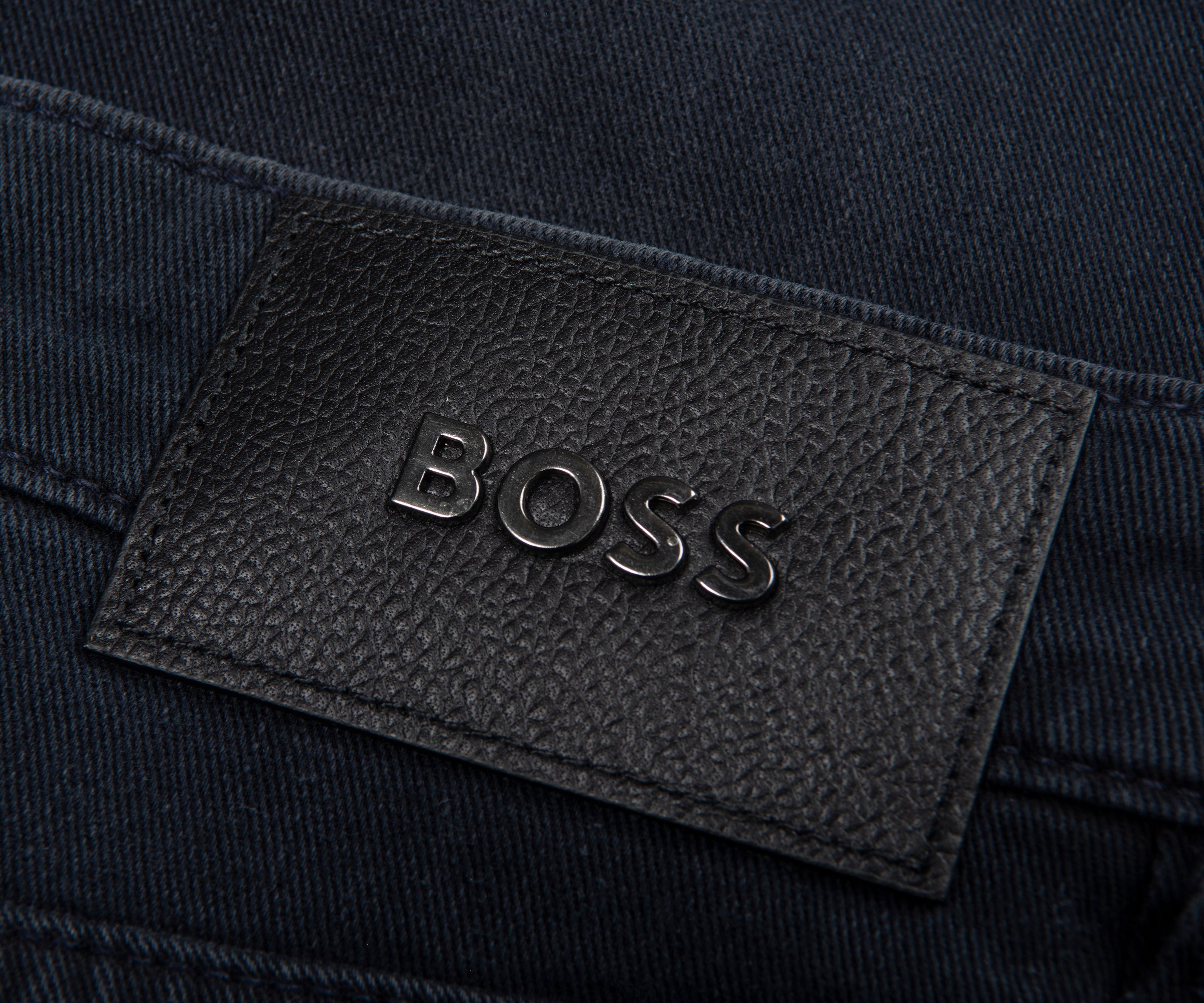 Close-up of a BOSS logo on dark fabric