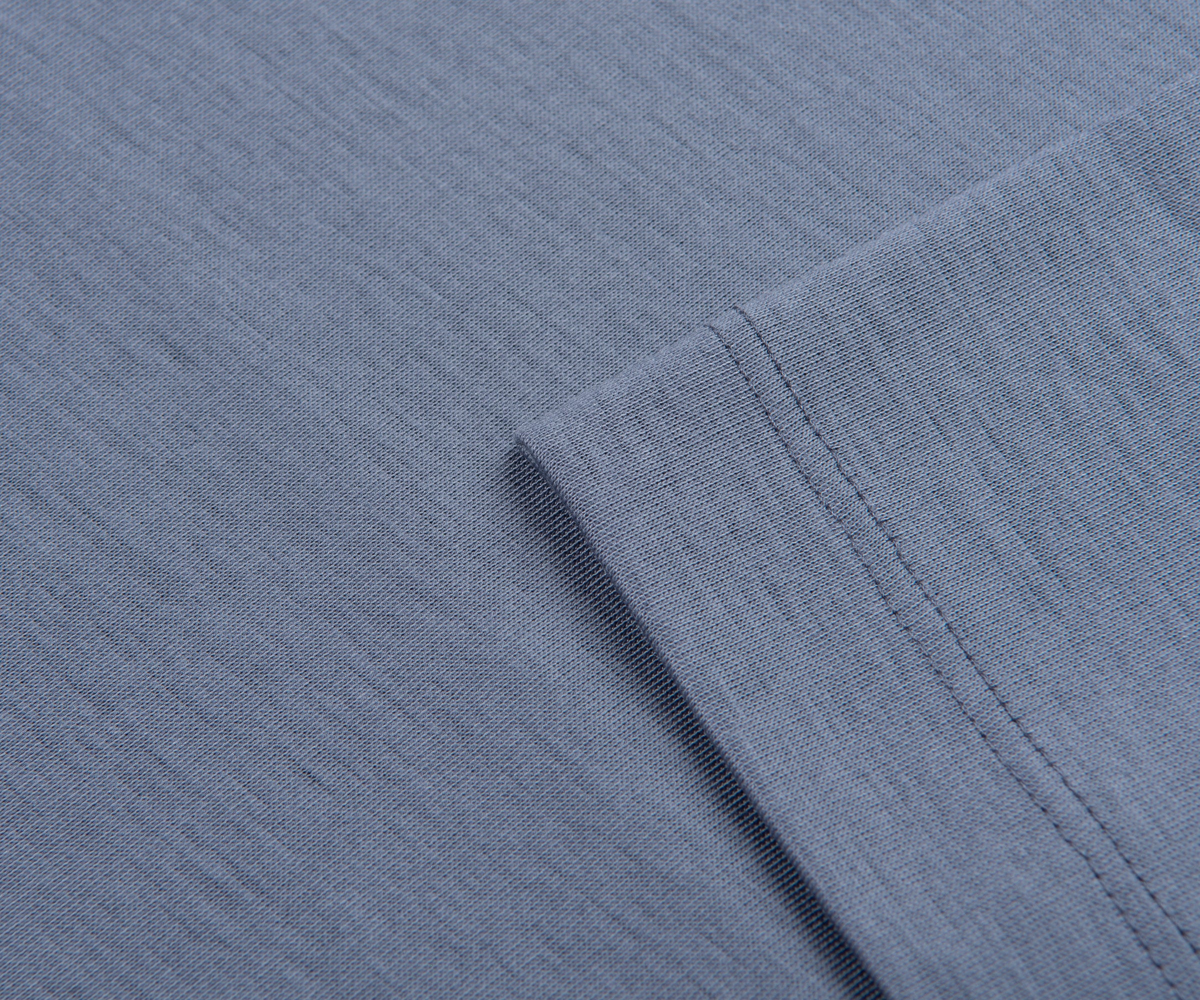 Close-up of blue fabric with a folded edge