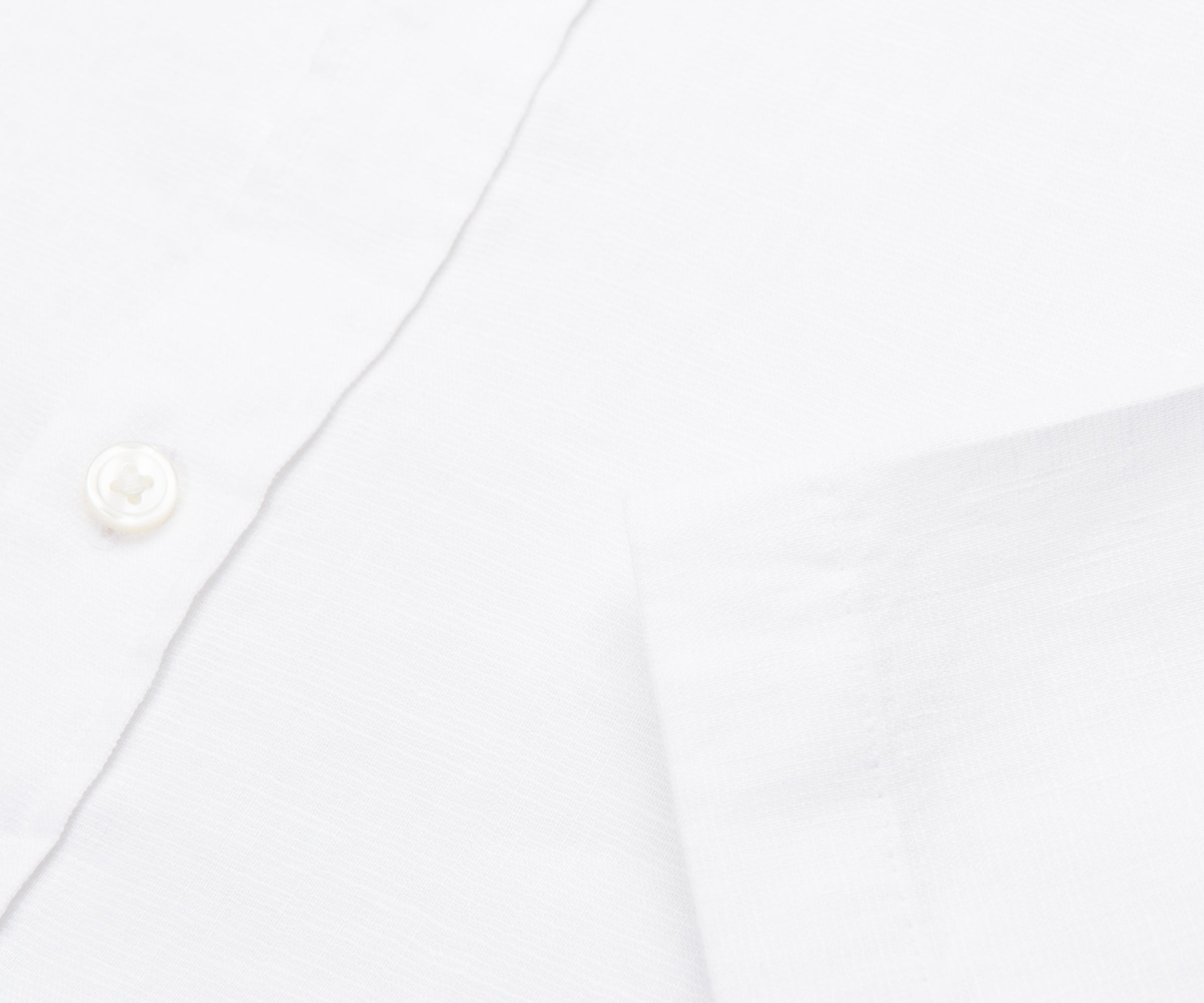 Close-up of a white shirt with a button on a white background