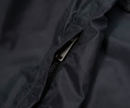 Close-up of a zipper on a dark fabric surface