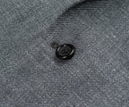 Close-up of a button on a textured gray fabric surface